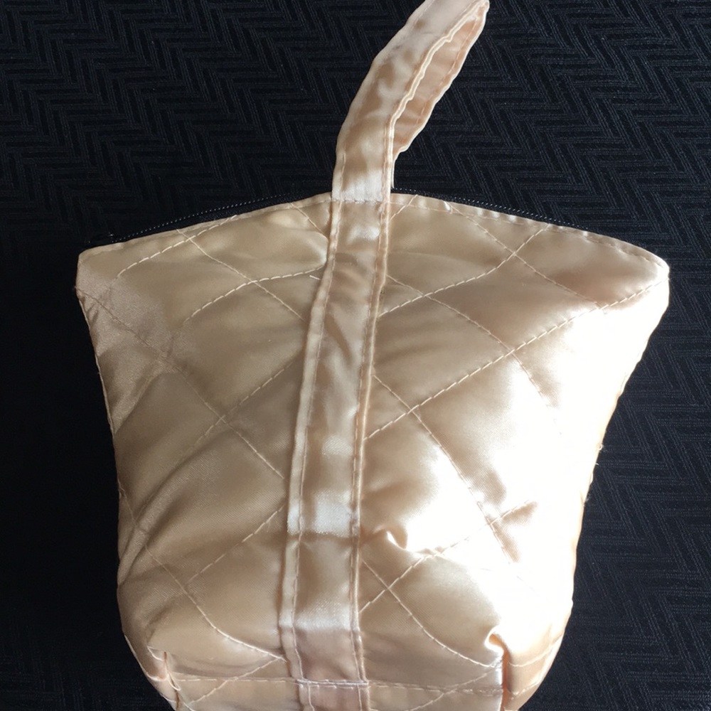 Adorable pink quilted cosmetic bag.